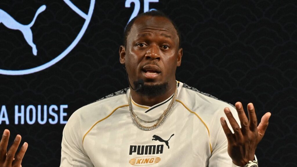 Usain Bolt and Australian teenage sprinter Gout Gout on an athletics track