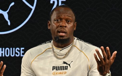 Usain Bolt and Australian teenage sprinter Gout Gout on an athletics track