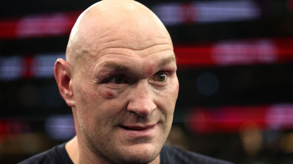 Oleksandr Usyk celebrating a heavyweight boxing victory in the ring