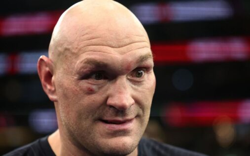 Oleksandr Usyk celebrating a heavyweight boxing victory in the ring