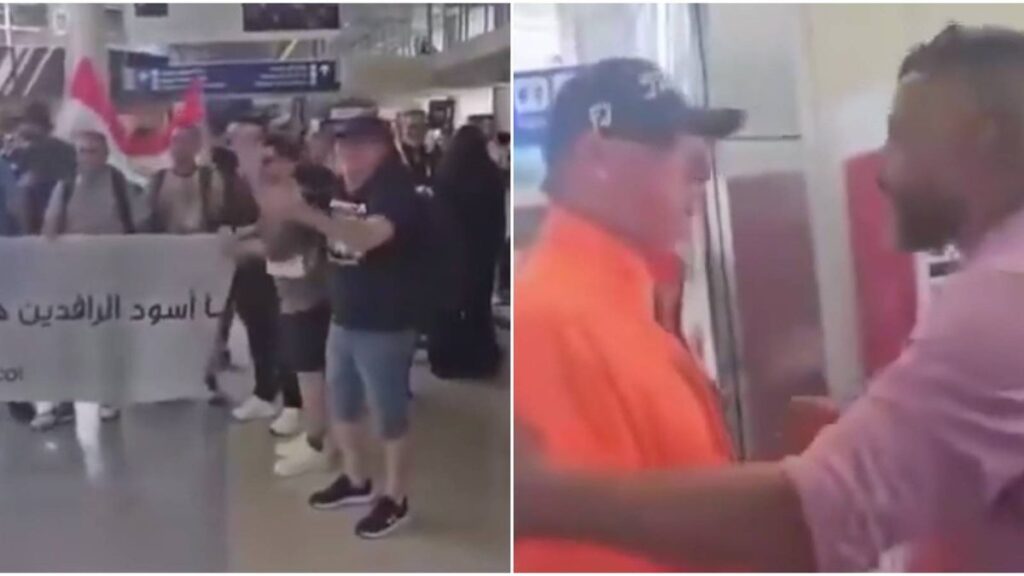 Iraqi football supporters gathered inside an airport terminal holding banners