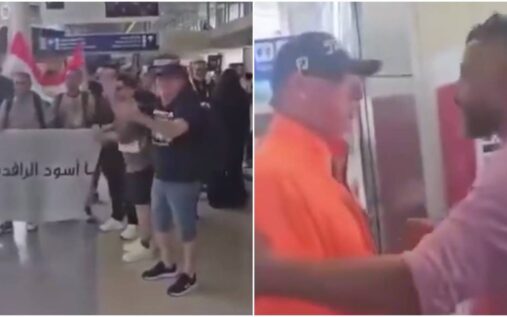 Iraqi football supporters gathered inside an airport terminal holding banners