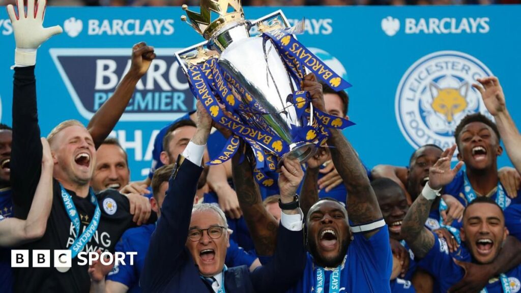 Marc Albrighton and Wes Morgan celebrating with the Premier League trophy