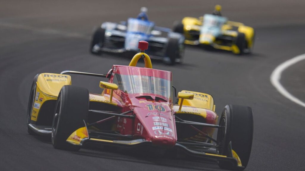 Alex Palou driving his IndyCar on the Indianapolis Motor Speedway oval