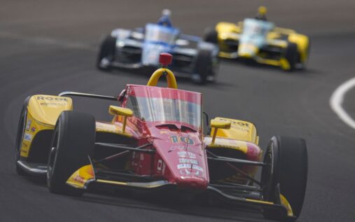 Alex Palou driving his IndyCar on the Indianapolis Motor Speedway oval