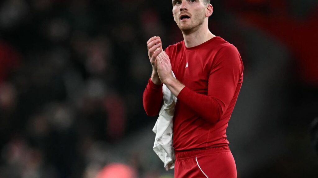 Andy Robertson clapping and waving to Liverpool supporters at Anfield