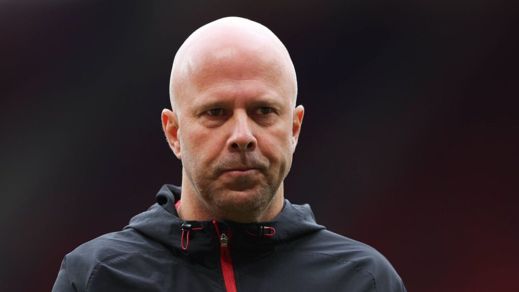 Liverpool manager Arne Slot looking thoughtful on the touchline during a Premier League match