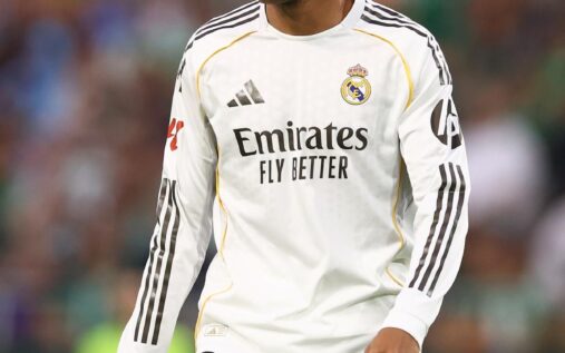 Kylian Mbappe looking thoughtful on the pitch wearing a Real Madrid kit