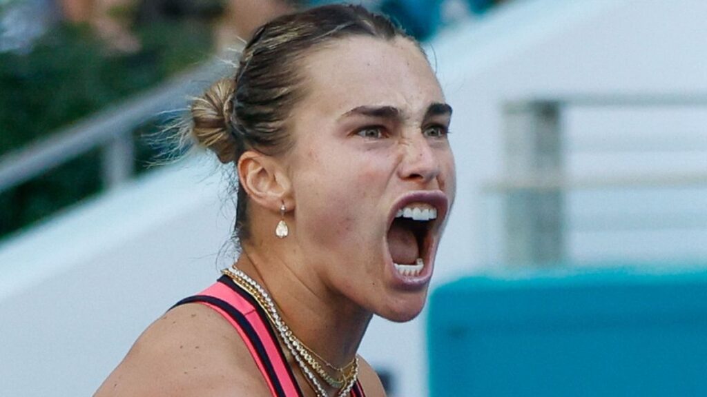 Aryna Sabalenka playing a tennis match on a clay court