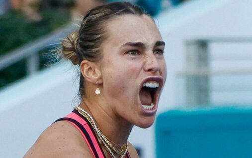 Aryna Sabalenka playing a tennis match on a clay court