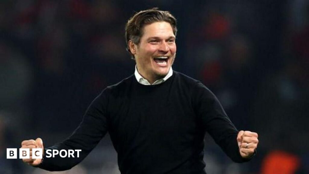 Edin Terzic standing on the touchline in a suit