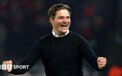 Edin Terzic standing on the touchline in a suit