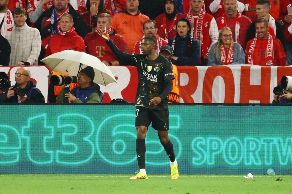 Ousmane Dembele handing a red lighter to the match referee during the Champions League semi-final