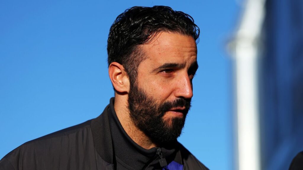 Ruben Amorim standing on the touchline wearing a suit