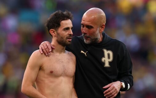Bernardo Silva and Pep Guardiola talking on the touchline during a Manchester City match