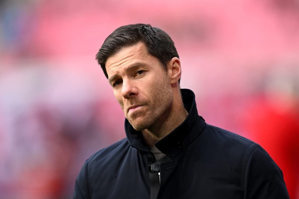 Xabi Alonso standing on the touchline giving instructions during a match