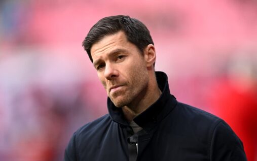 Xabi Alonso standing on the touchline giving instructions during a match