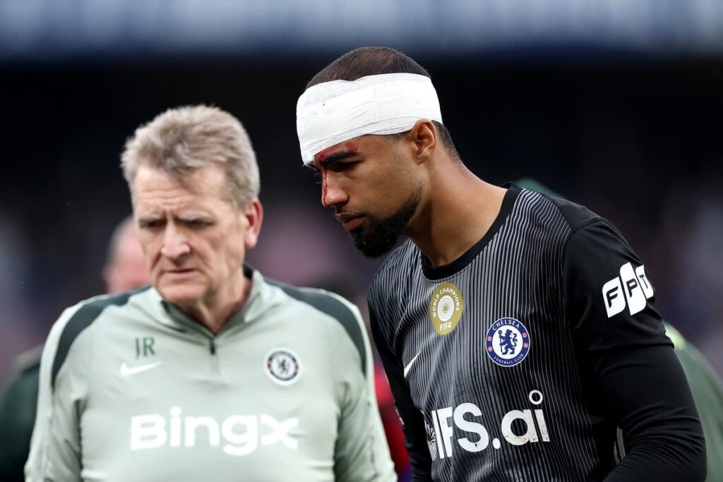 Chelsea goalkeeper Robert Sanchez wearing a head bandage on the pitch