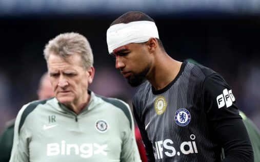 Chelsea goalkeeper Robert Sanchez wearing a head bandage on the pitch