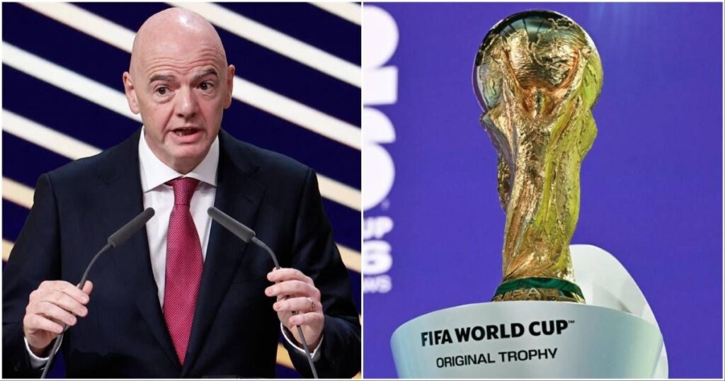 The FIFA World Cup trophy displayed alongside broadcasting cameras inside a packed international football stadium.