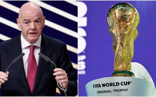 The FIFA World Cup trophy displayed alongside broadcasting cameras inside a packed international football stadium.