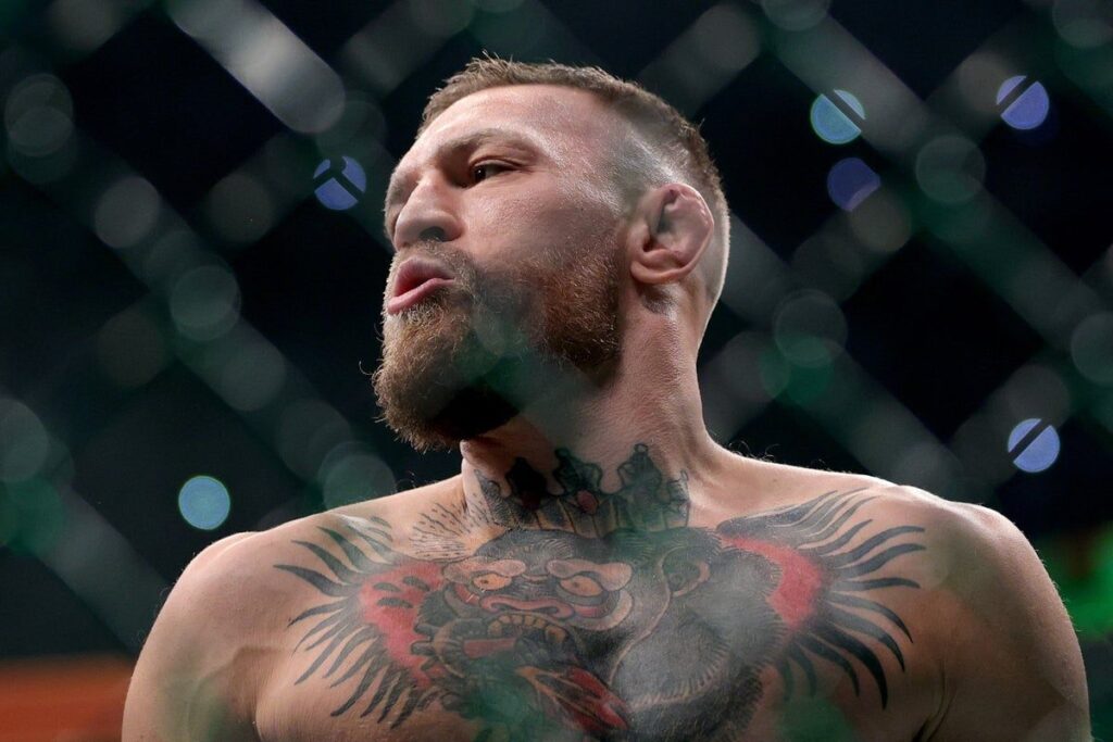 Conor McGregor and Max Holloway facing off inside the UFC Octagon