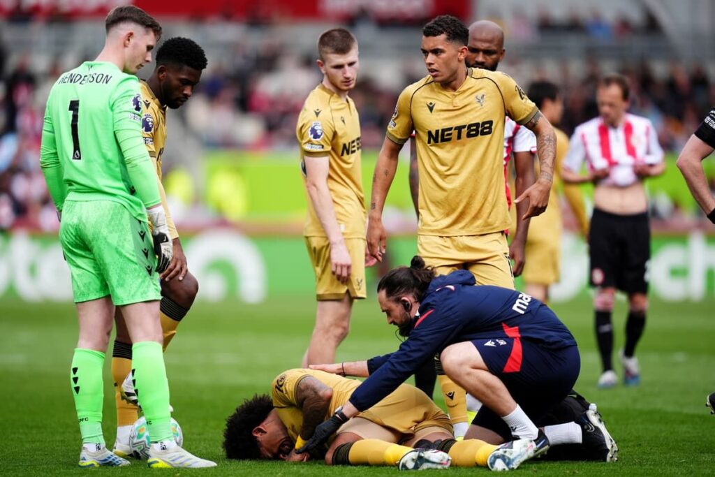 Crystal Palace defender Chris Richards walking off the pitch visibly upset after sustaining an injury