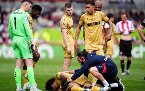 Crystal Palace defender Chris Richards walking off the pitch visibly upset after sustaining an injury
