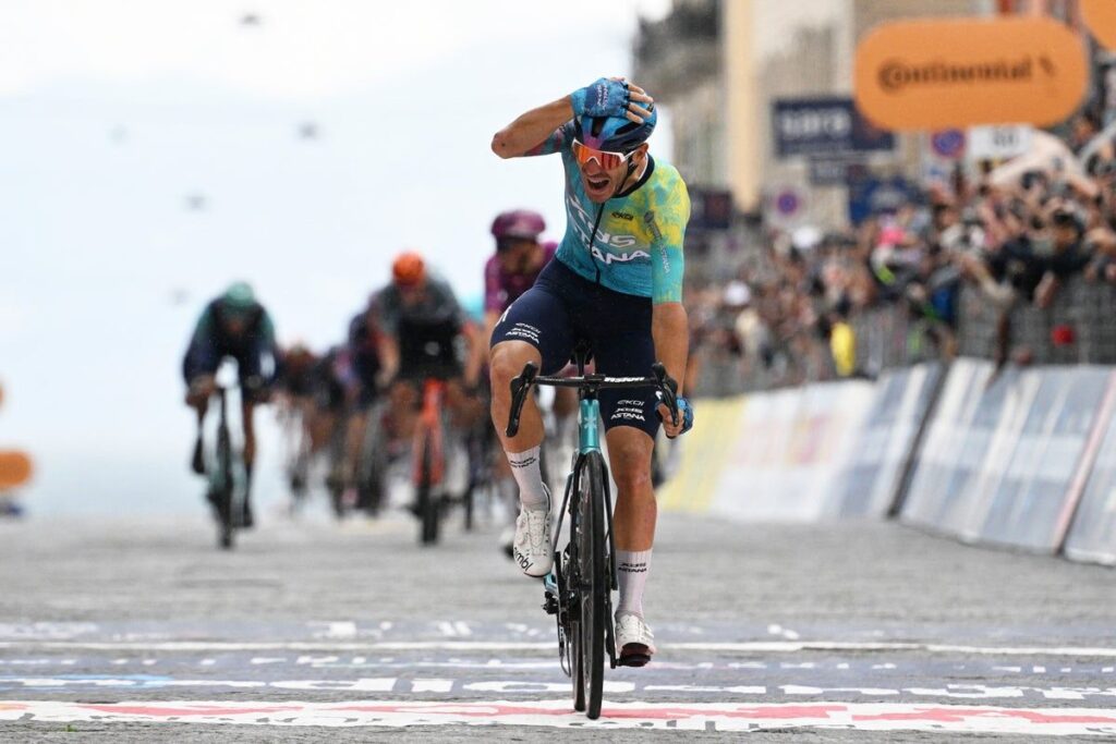 Davide Ballerini celebrating as he crosses the finish line to win stage six of the Giro d'Italia