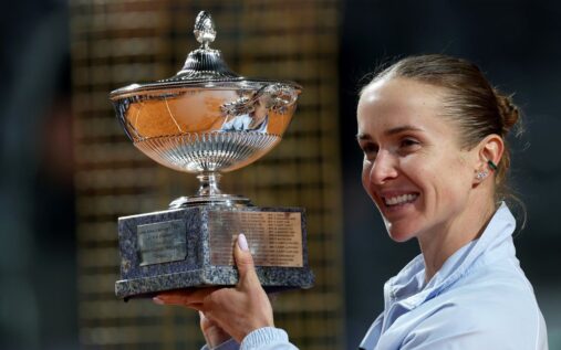 Elina Svitolina and Marta Kostyuk holding their respective WTA tennis championship trophies