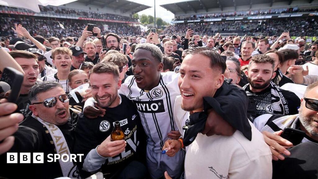 Elversberg supporters spilling onto the pitch to celebrate their historic promotion to the Bundesliga