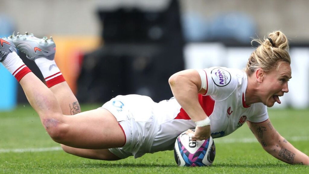 England and France women's rugby players competing in a physical Six Nations match