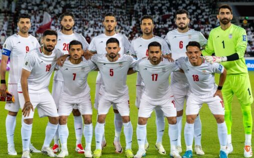 Iran national football team players lining up on the pitch before a match