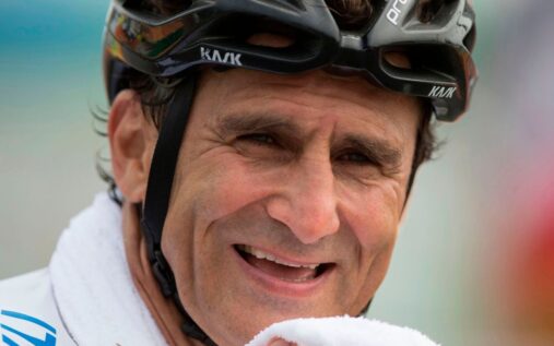 Alex Zanardi smiling while holding a gold medal at the Paralympic Games