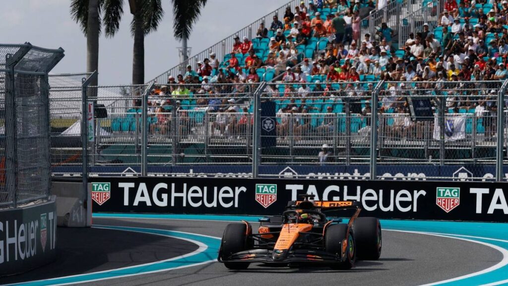 Formula 1 cars racing on a wet track under stormy skies at the Miami Grand Prix