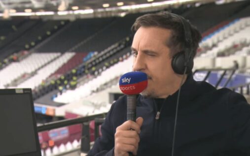 Gary Neville speaking into a broadcasting microphone while analysing a football match