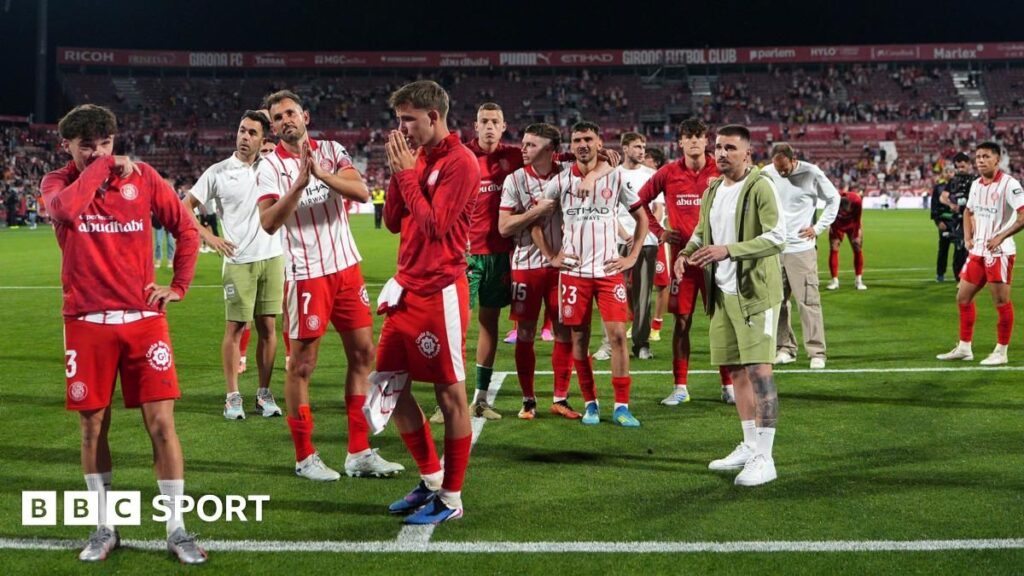 Girona players look dejected on the pitch after their relegation from La Liga is confirmed