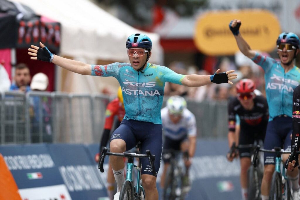 Guillermo Thomas Silva celebrating his stage two victory at the Giro d'Italia while wearing the pink jersey