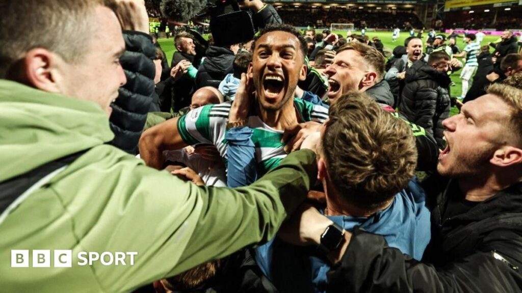 Celtic and Hearts players competing during a tense Scottish Premiership match