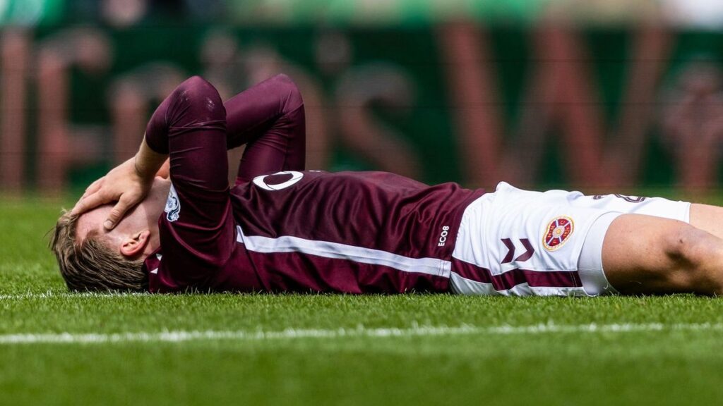 Celtic fans invading the pitch at Parkhead while Hearts players leave the field