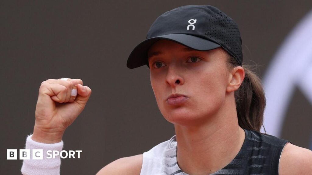 Iga Swiatek hitting a powerful shot on the clay courts of the Italian Open in Rome