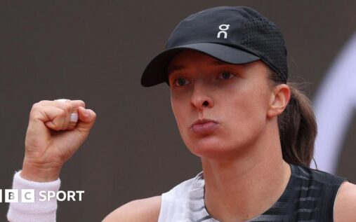 Iga Swiatek hitting a powerful shot on the clay courts of the Italian Open in Rome