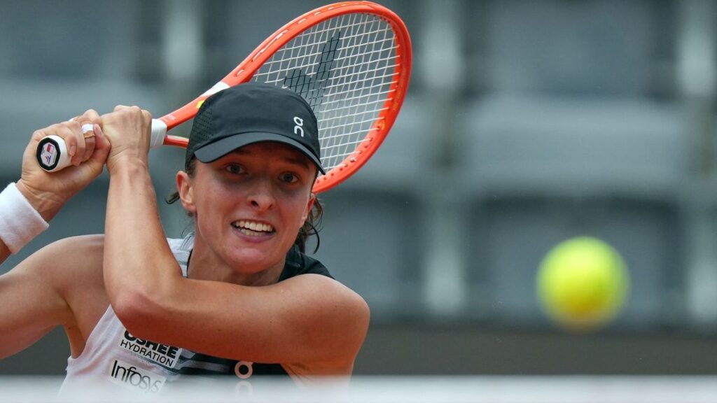 Iga Swiatek hitting a forehand during her three-set victory over Caty McNally at the Italian Open in Rome