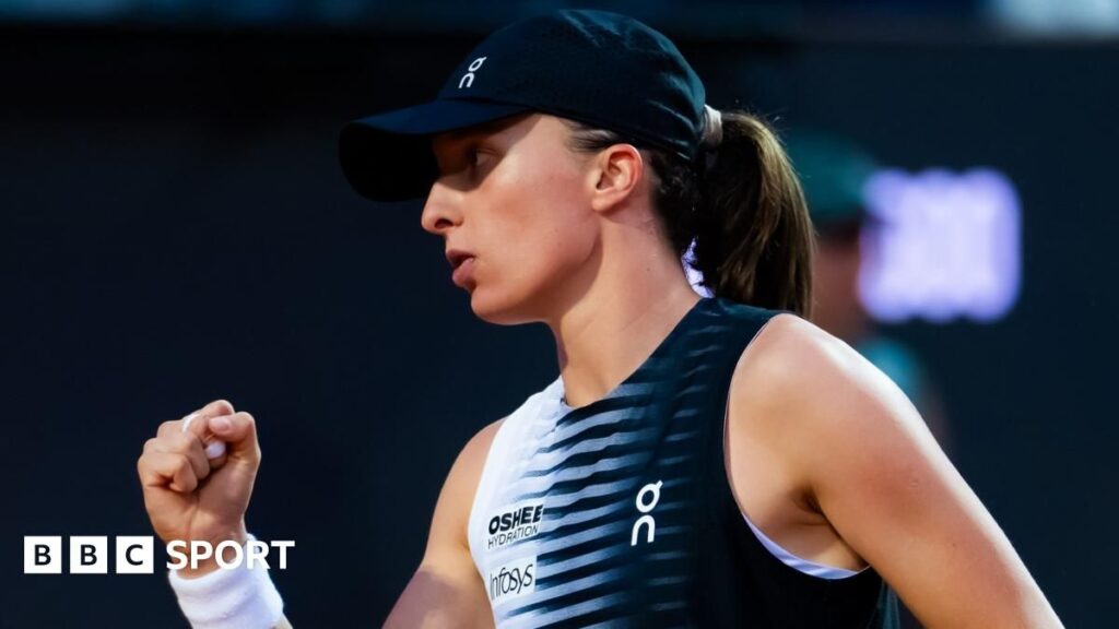 Iga Swiatek hitting a forehand on the clay courts at the Italian Open in Rome