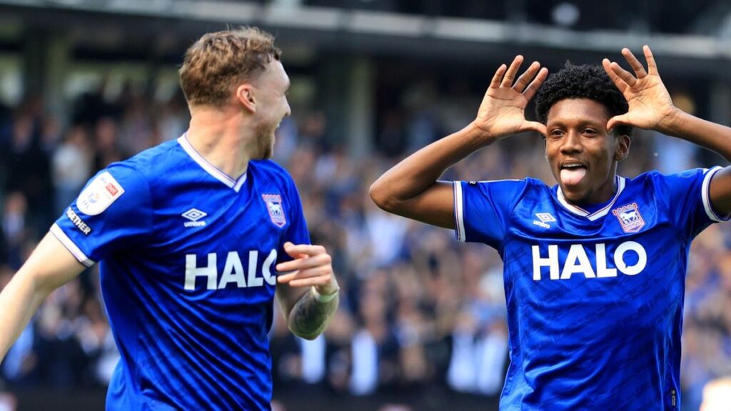 Ipswich Town players celebrate on the pitch at Portman Road after securing promotion to the Premier League.