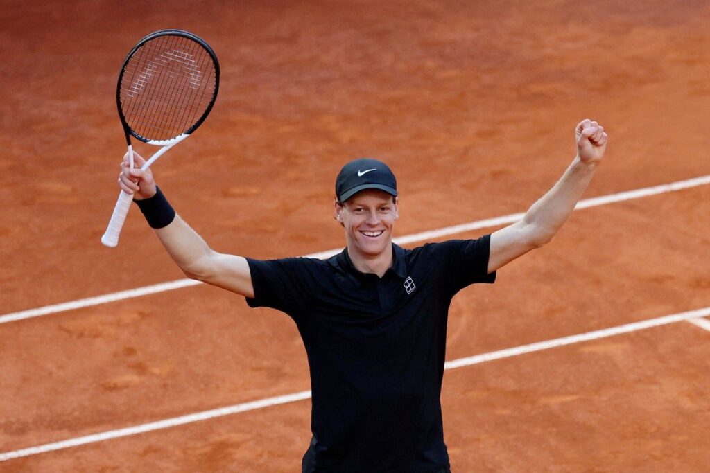 Jannik Sinner celebrating with the Italian Open trophy on the clay court in Rome
