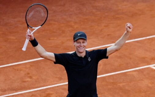 Jannik Sinner celebrating with the Italian Open trophy on the clay court in Rome