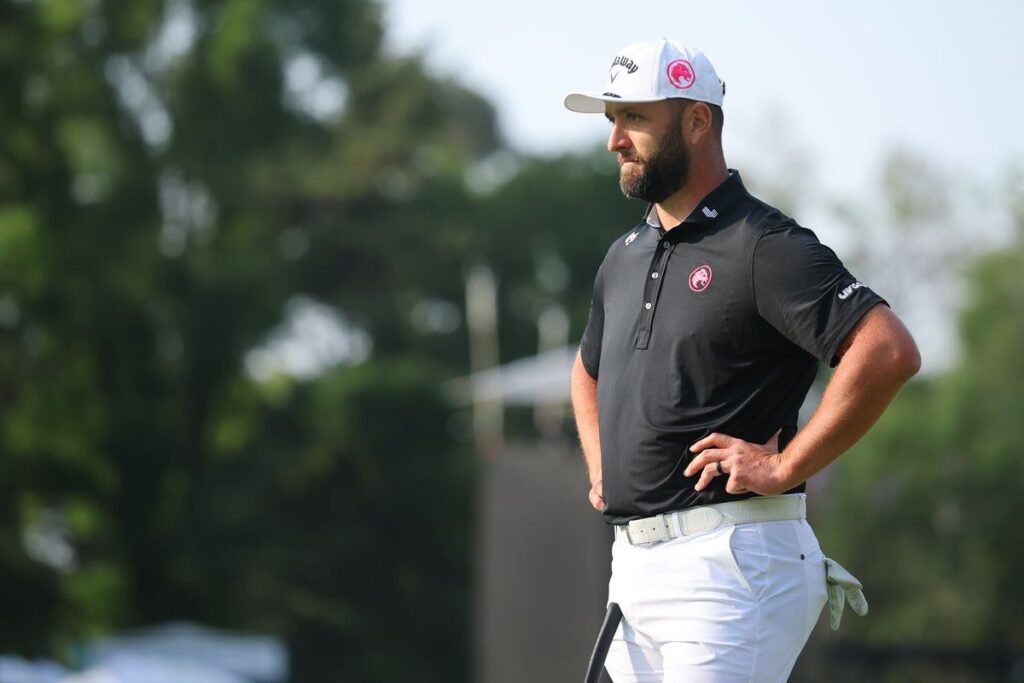 Jon Rahm standing on the golf course watching his shot during a tournament