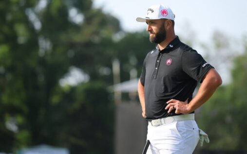 Jon Rahm standing on the golf course watching his shot during a tournament