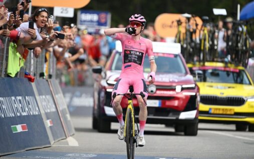 Jonas Vingegaard celebrates crossing the finish line alone in the pink jersey to win stage 16 of the Giro d'Italia
